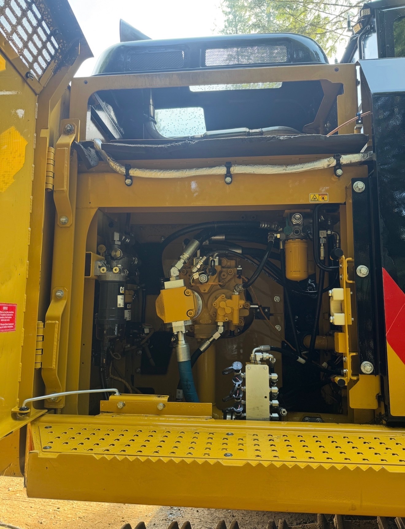 Clean pump and hydraulic bay inside a Cat excavator after degreasing