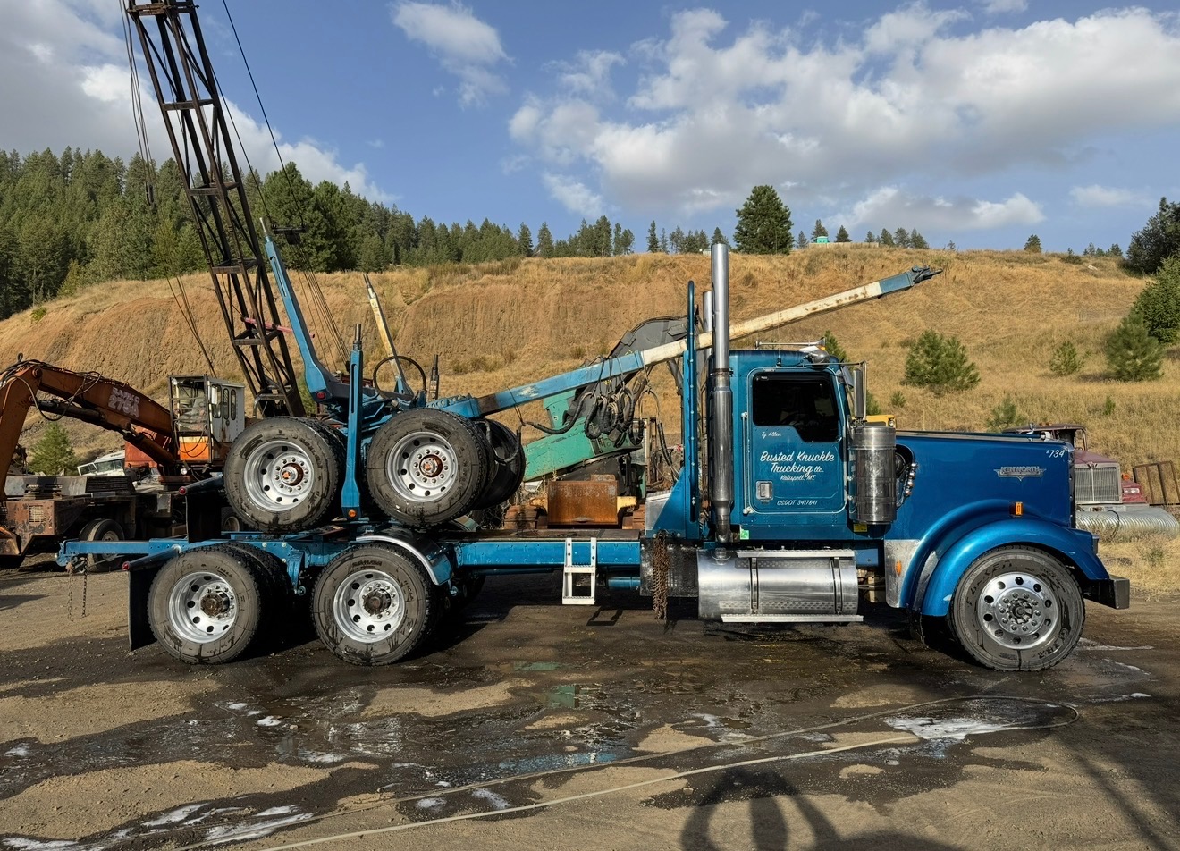Blue log truck washed clean at an Idaho equipment yard