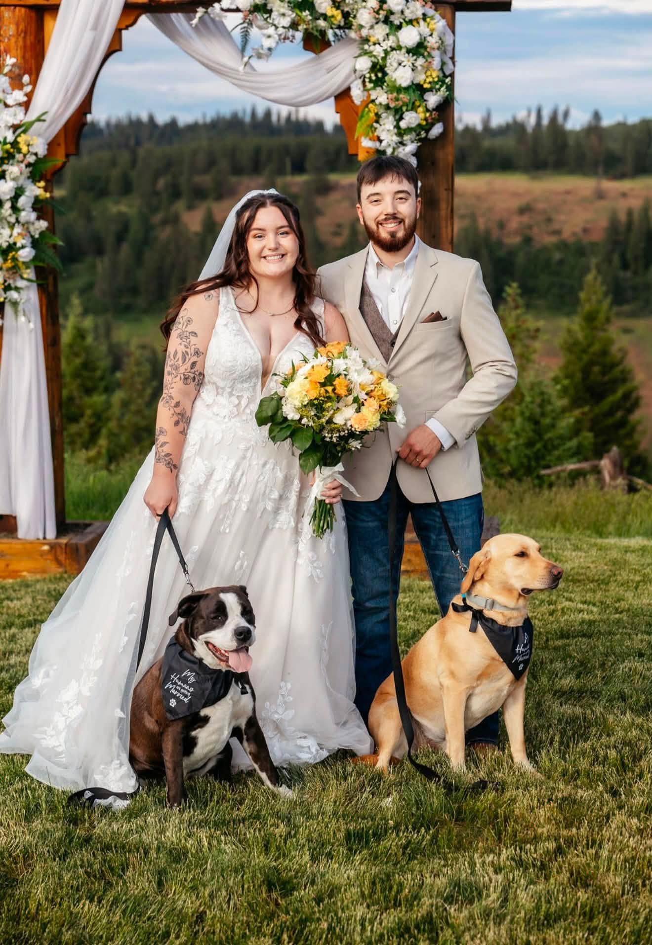 The husband-and-wife owners of Gem State Pressure Washing with their two dogs