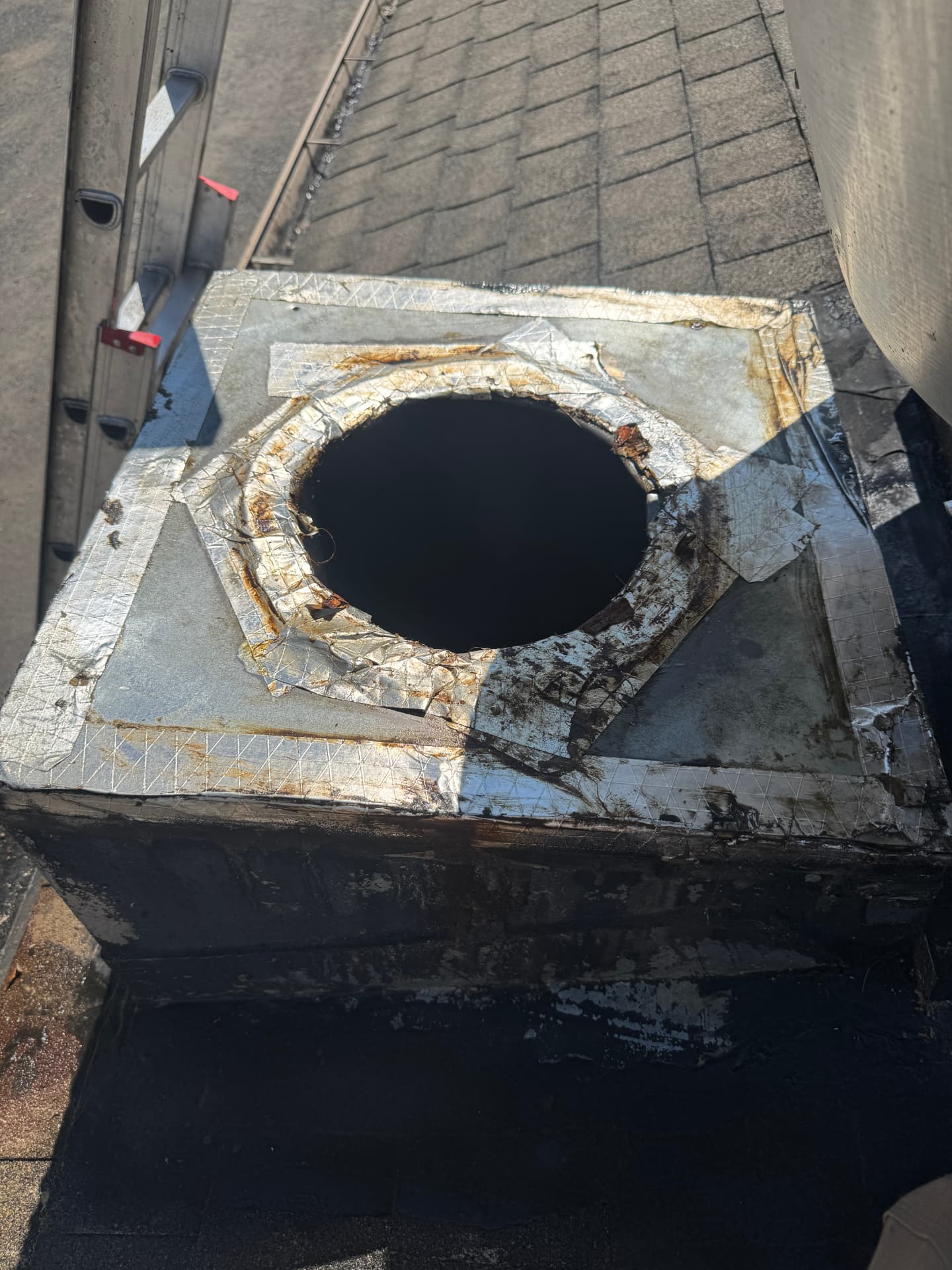 Rooftop commercial kitchen exhaust curb and vent opening serviced during a hood cleaning